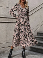 Women's printed polyester midi dress with a V-neckline and long sleeves.