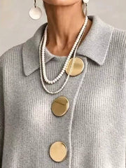 Close up of the light gray cardigan collar and large gold buttons