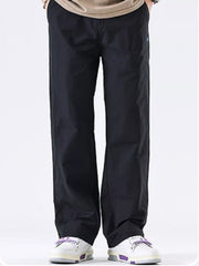 Men's black wide-leg casual pants with a polyester-blend composition.