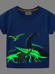 Front view of the same royal blue children's t shirt with glowing green dinosaurs on dark fabric