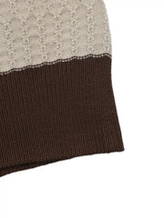 Close up of the cream textured stripe meeting the brown ribbed hem on the top