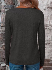 Back view of a dark gray long-sleeve V-neck top worn with blue jeans