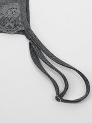 Close view of grey thin strap and lace detail on the mini dress