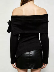 Back view of black off shoulder ribbed knit top with wide neckline and asymmetric hem