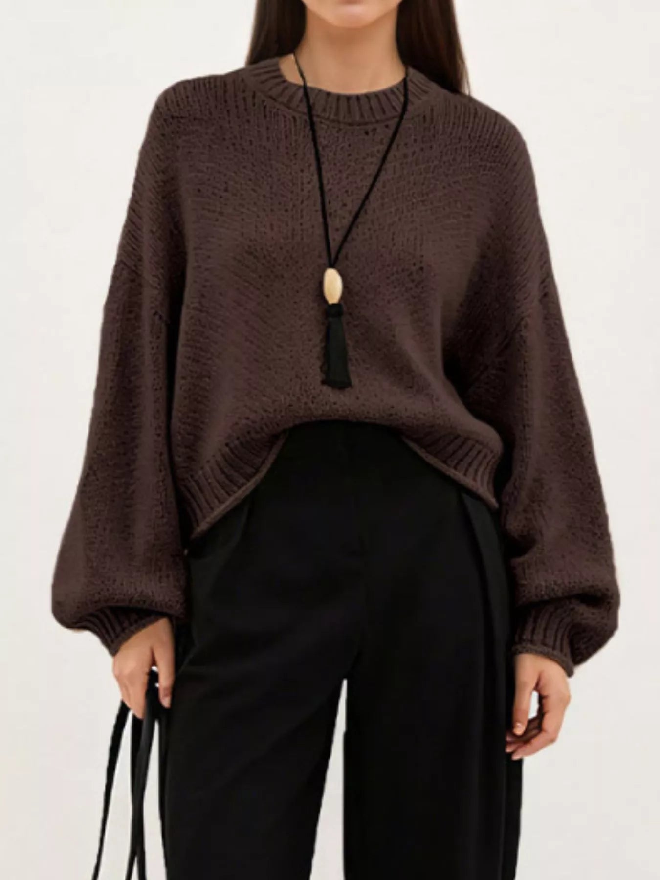 On-model front view of a brown oversized chunky knit sweater with balloon sleeves