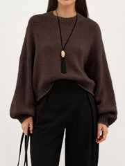 On-model front view of a brown oversized chunky knit sweater with balloon sleeves