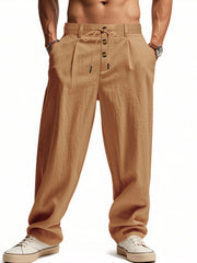 Men's earthy yellow loose-fit pants with a drawstring waist and pockets.