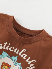 Close-up of ribbed crew neckline and stitching on dark brown children's tee