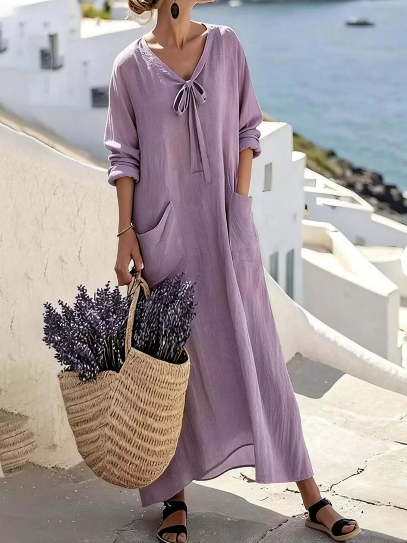 Model wearing light purple long sleeve loose maxi dress outdoors, full view with large pockets and tie neck