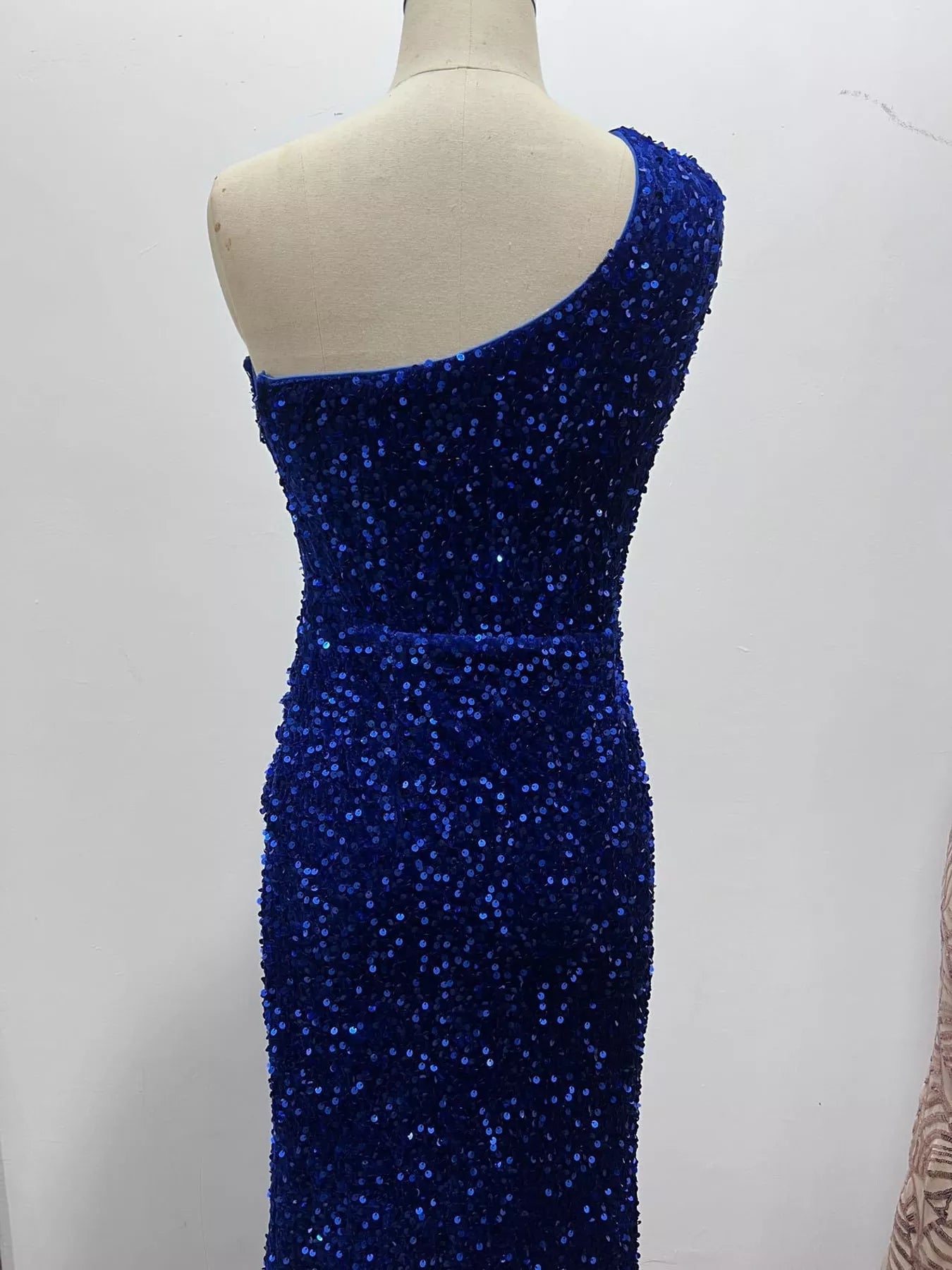 Royal blue sequin one shoulder evening dress rear bodice view on a dress form