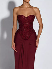 Red strapless sequin corset bodice and draped waist, close front view on model
