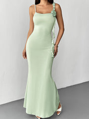 Front view of a light green floral bodycon mermaid maxi dress with a fabric rose at the shoulder