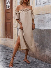 Front view of women's tan off-shoulder midi dress showing the side slit, puff sleeves, and lace-up sandals.