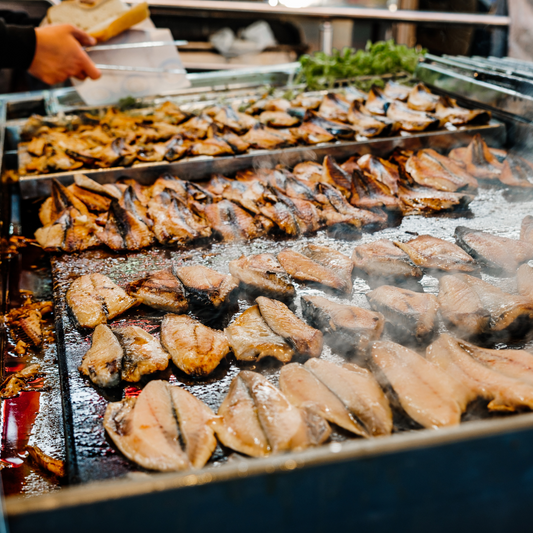 an image of fish being cooked on a grill tray