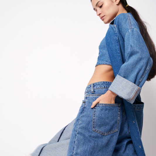 a person in a denim shirt and jeans