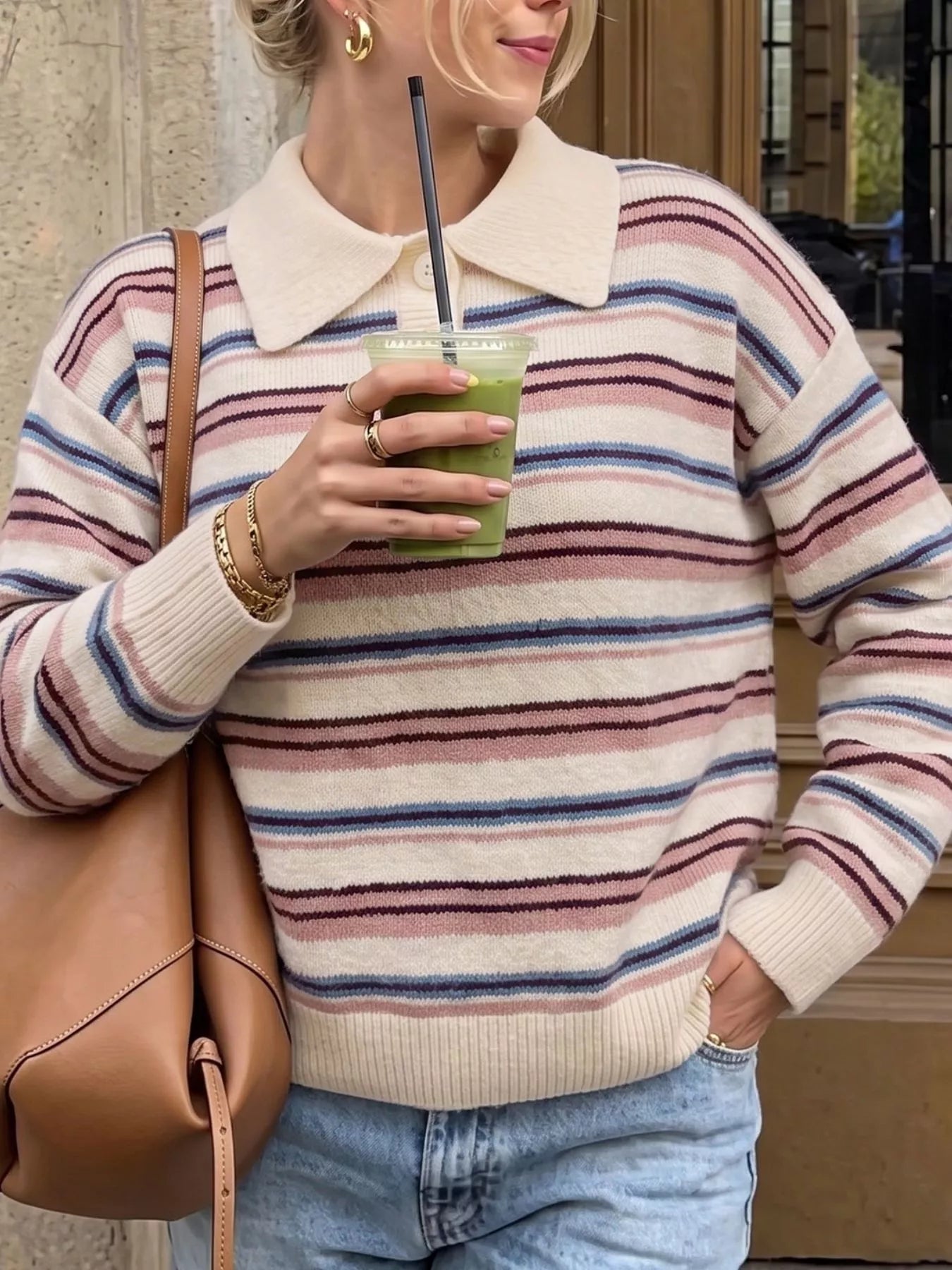 Front view of a cream striped polo sweater with pink, burgundy, and blue stripes
