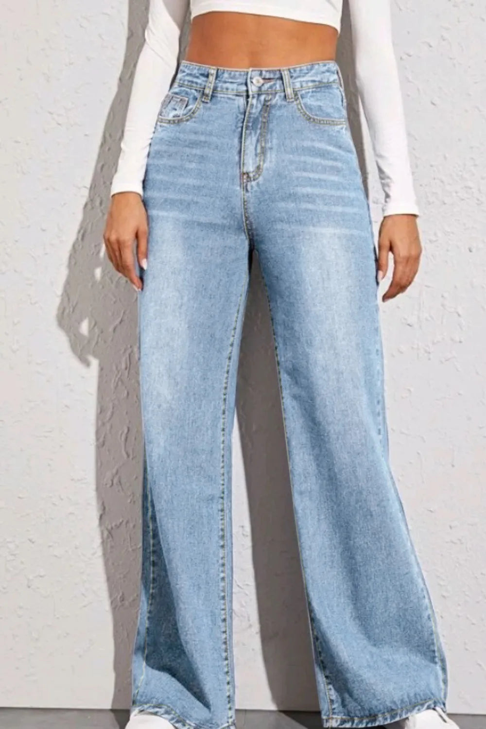 Women's high-waist jeans with a wide-leg silhouette in a cotton-polyester blend.