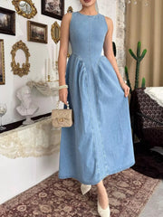 Light blue sleeveless denim midi dress with fitted bodice and flared skirt, front view indoors