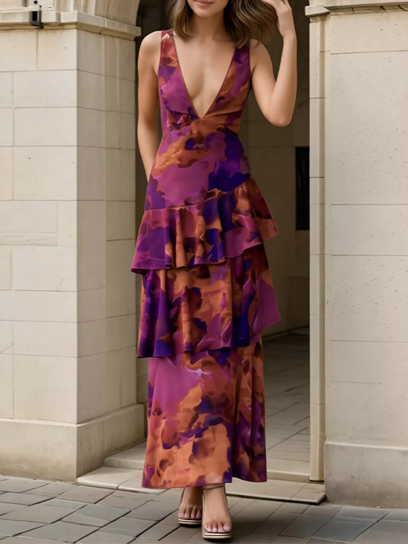 Three quarter front view of a deep purple floral V neck maxi dress with tiered ruffle layers