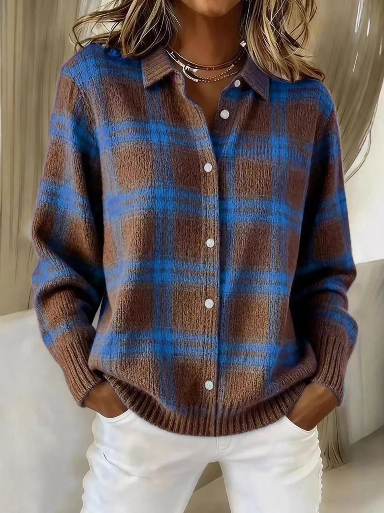 On-model front view of a brown and blue plaid button-down knit cardigan with long sleeves