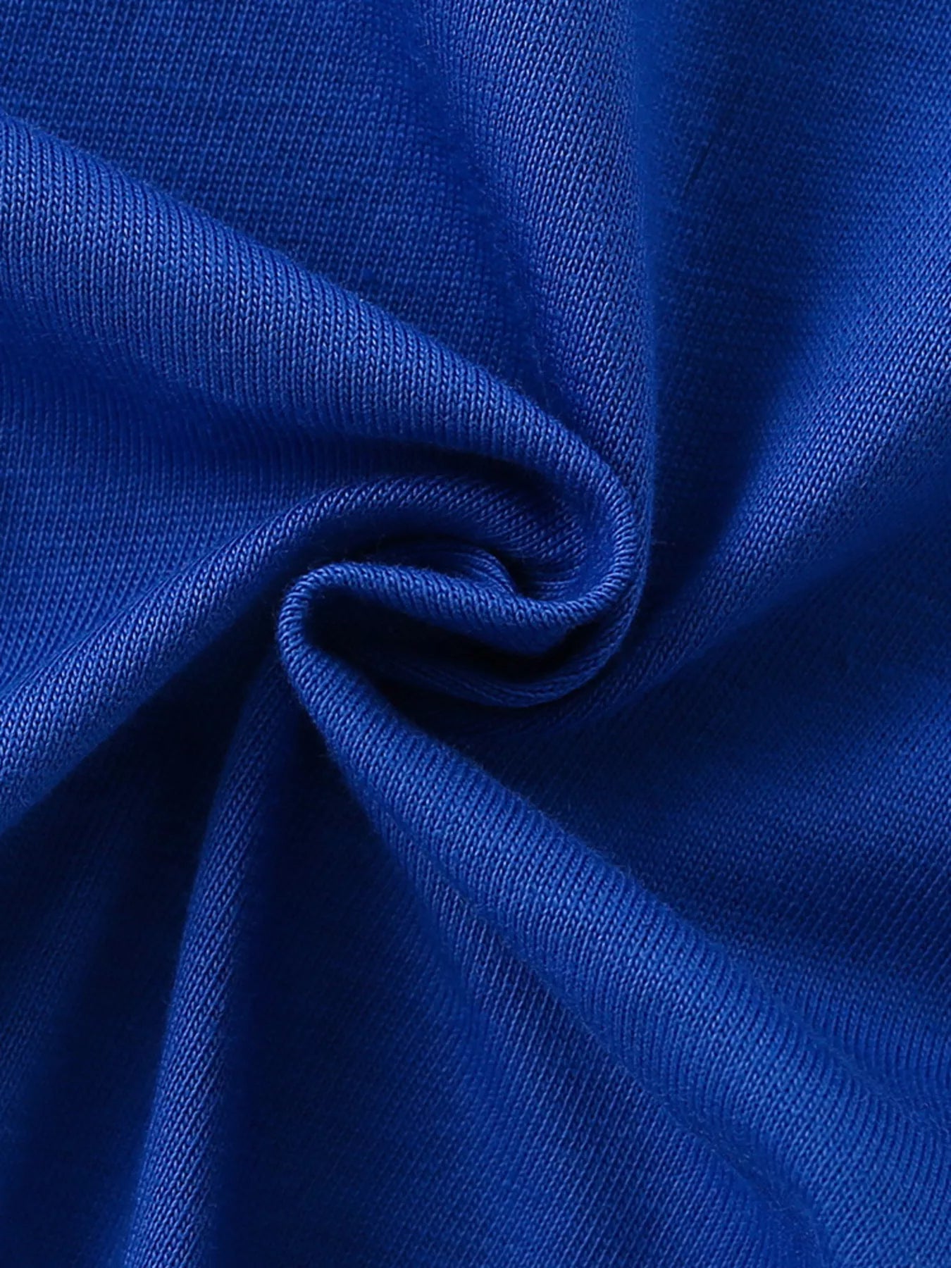 Close-up of twisted royal blue fabric showing the children's t-shirt knit texture