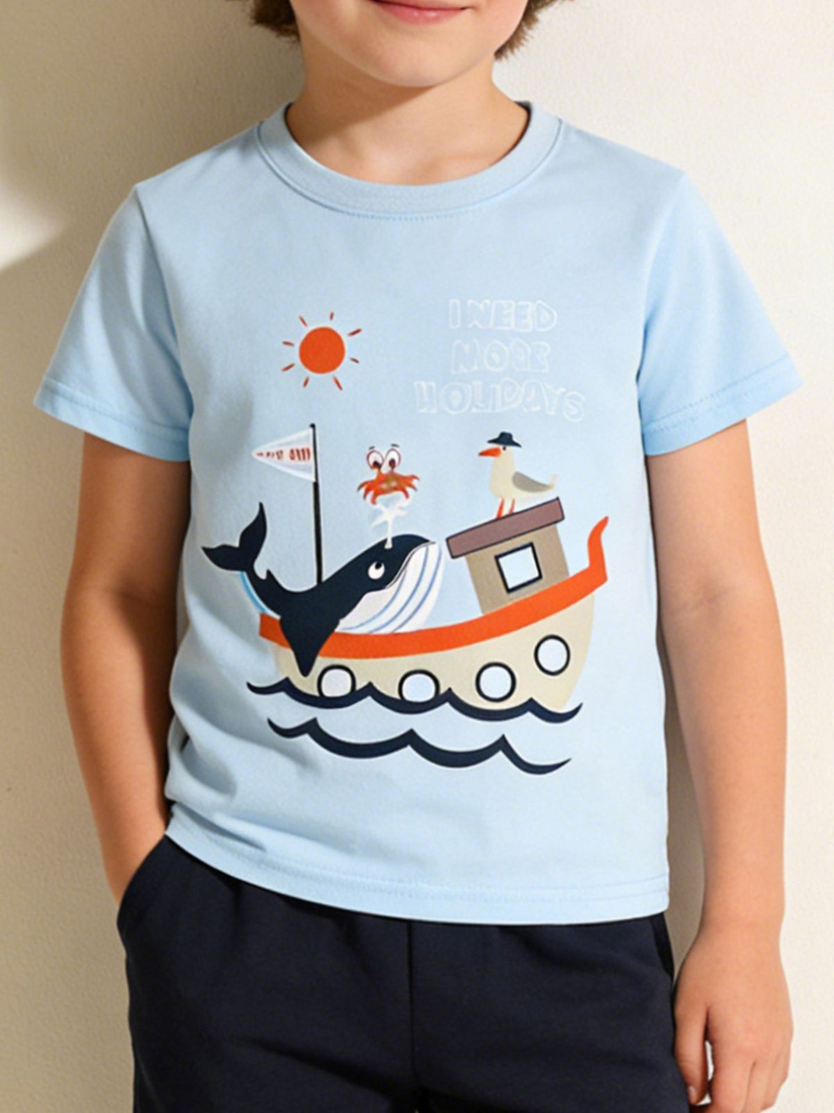 Front view of a light blue children's short sleeve tee with a whale boat graphic
