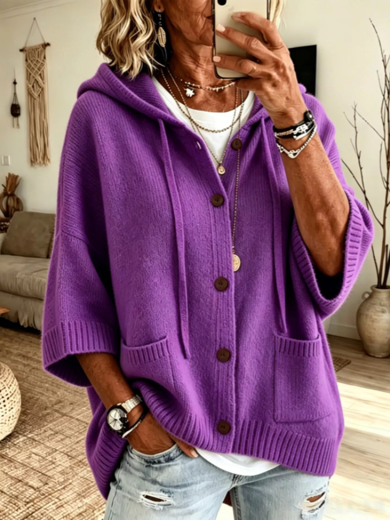 Purple hooded knit cardigan with brown buttons and patch pockets shown from the front on model