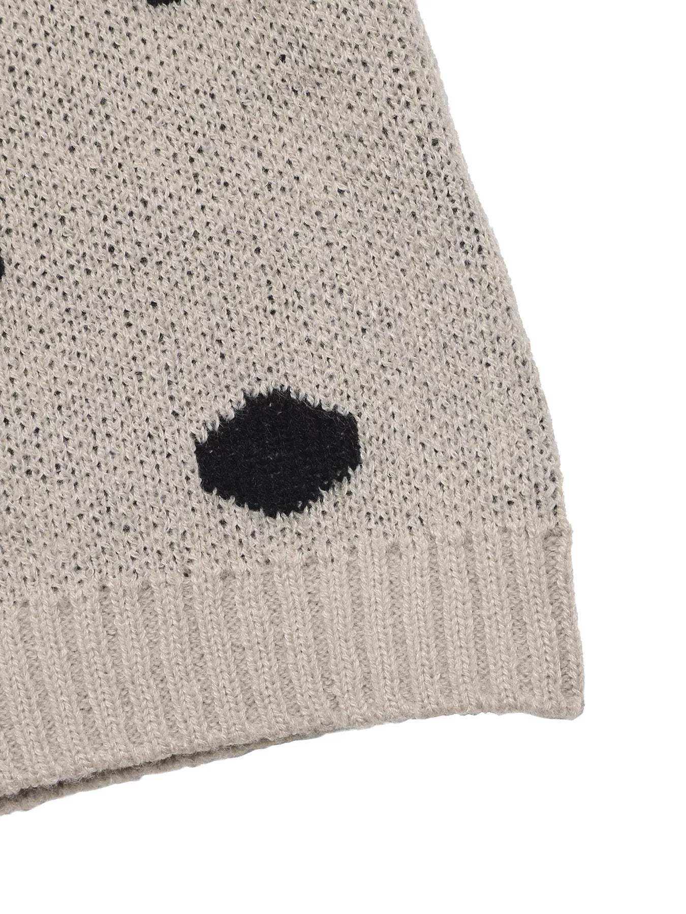 Close up of khaki polka dot sweater ribbed hem and knit texture detail
