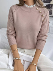 Front view of a pink knit sweater with openwork sleeves, lace collar, and gold buttons