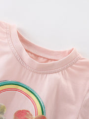 Close-up of ribbed crew neckline and top of rainbow print on blush pink tee