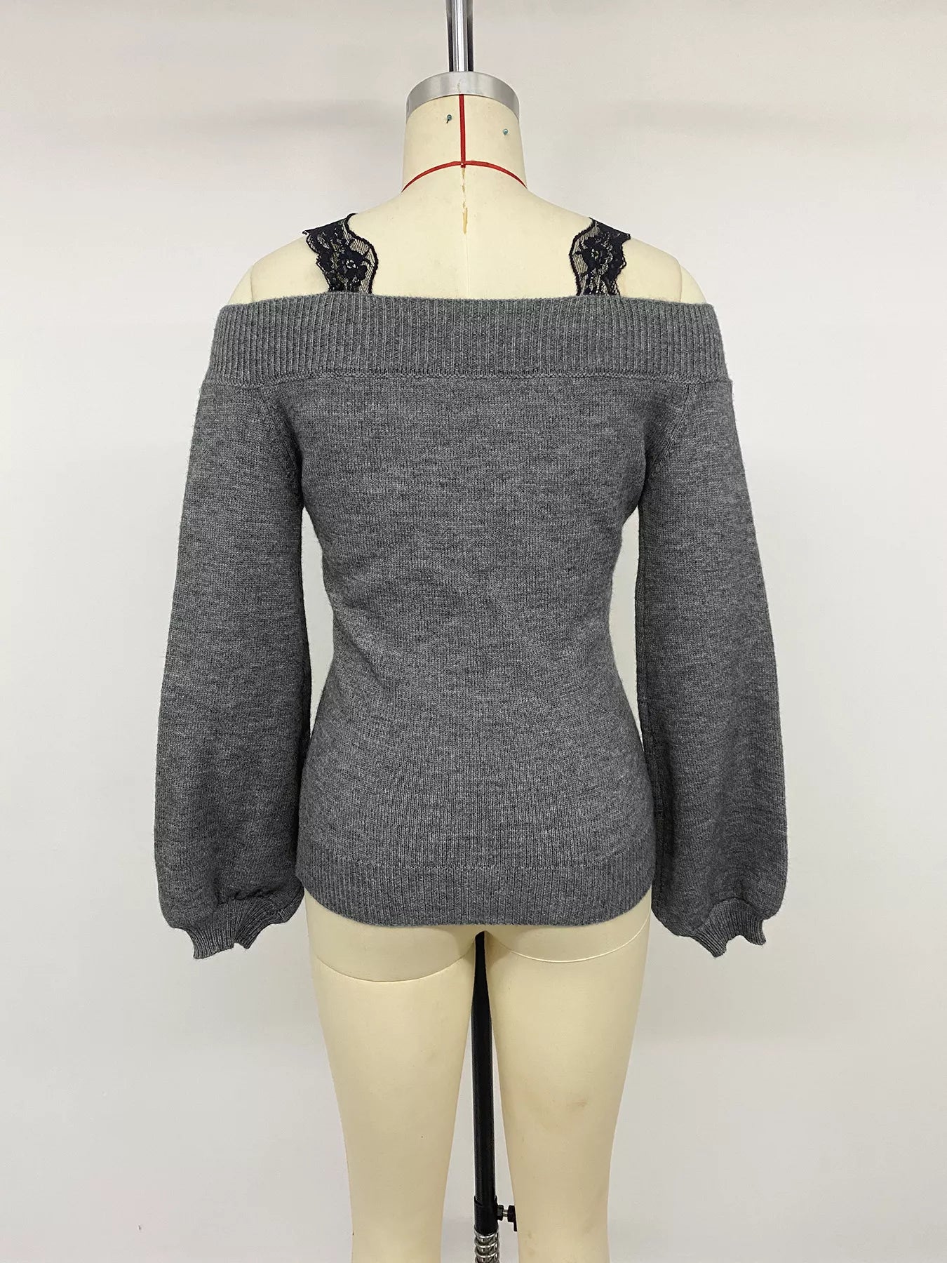 Back view of dark grey off shoulder lace trim sweater displayed on mannequin