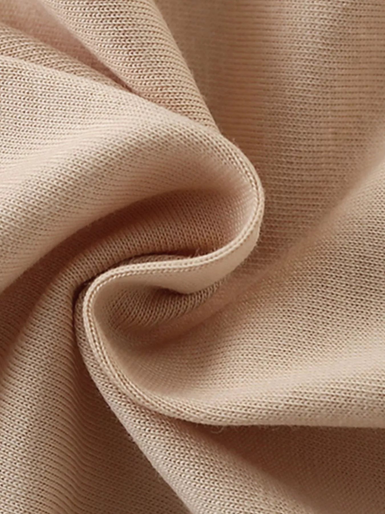 Close-up texture of the soft tan fabric of the children's sleeveless top