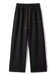 Men's loose fit casual pants with a drawstring waist and pockets.