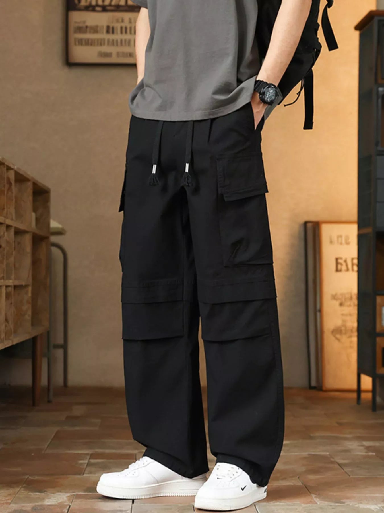 Men's relaxed fit cargo pants with a drawstring waist and pockets.