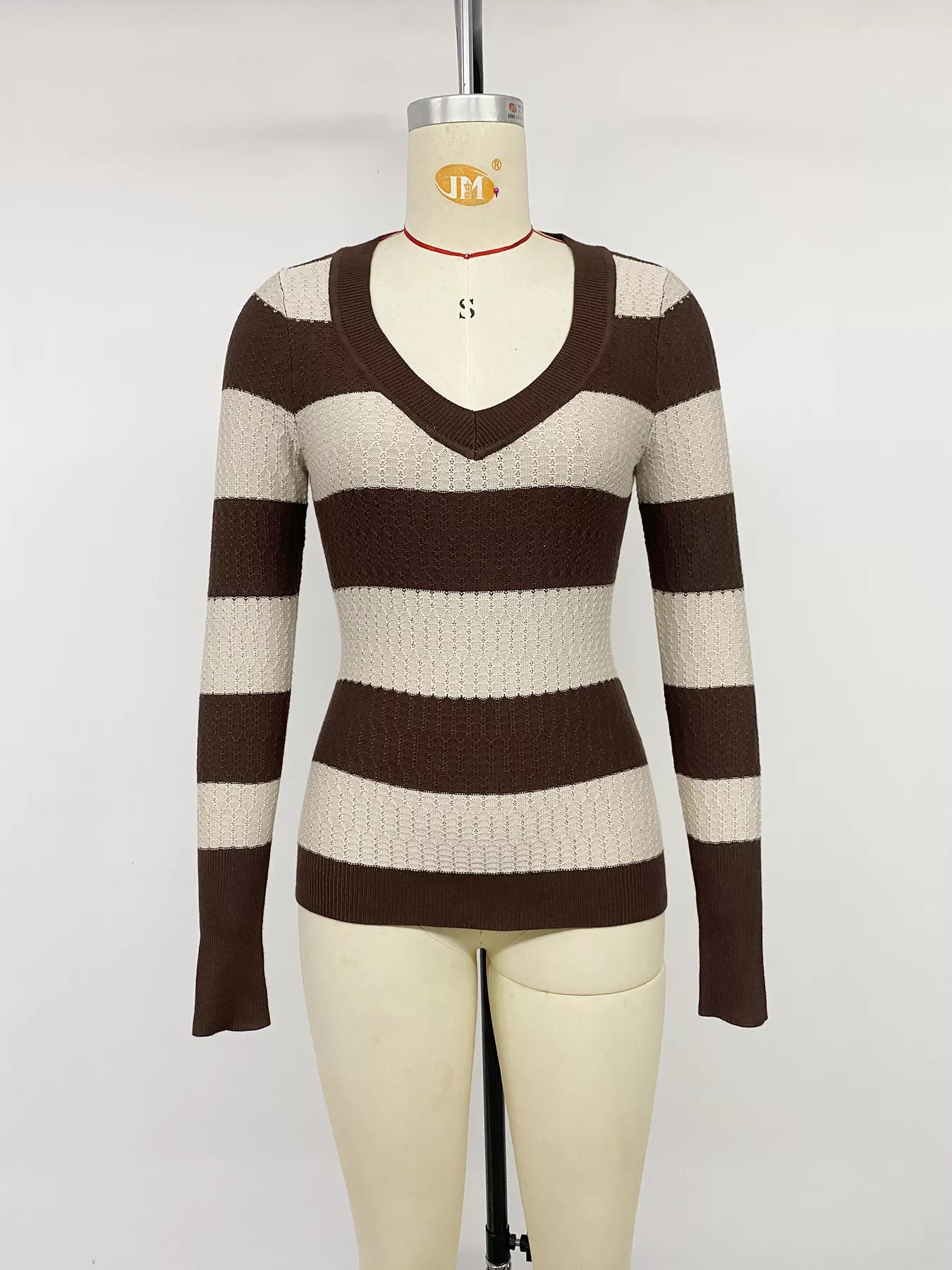 Front view of the striped V neck knit top displayed on a dress form