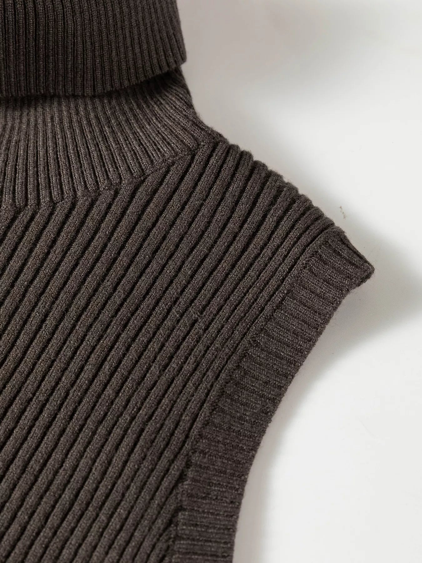 Close up of coffee brown ribbed shoulder and armhole on sweater vest