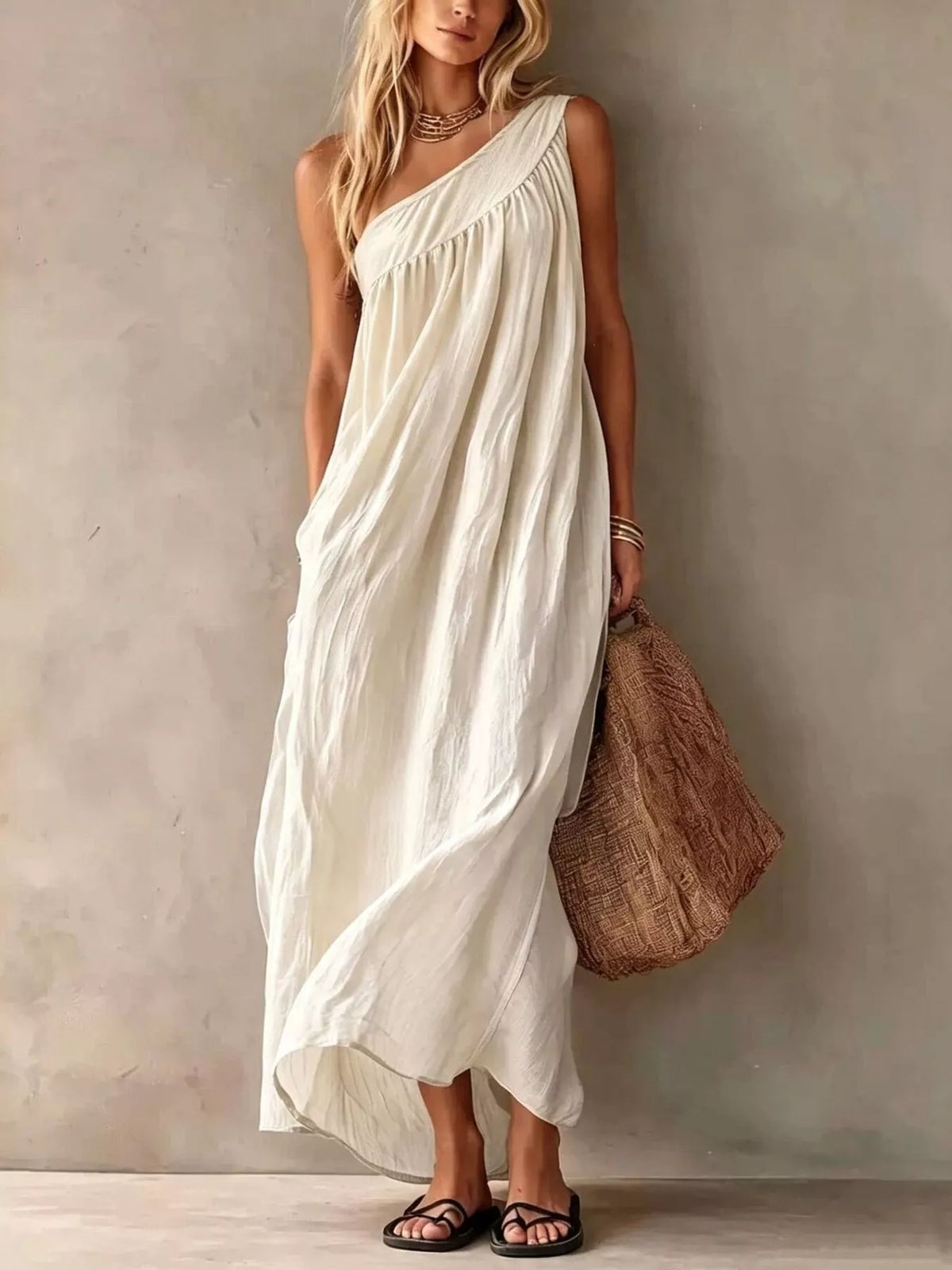 Full length front view of a white one shoulder maxi dress with gathered bodice on a model