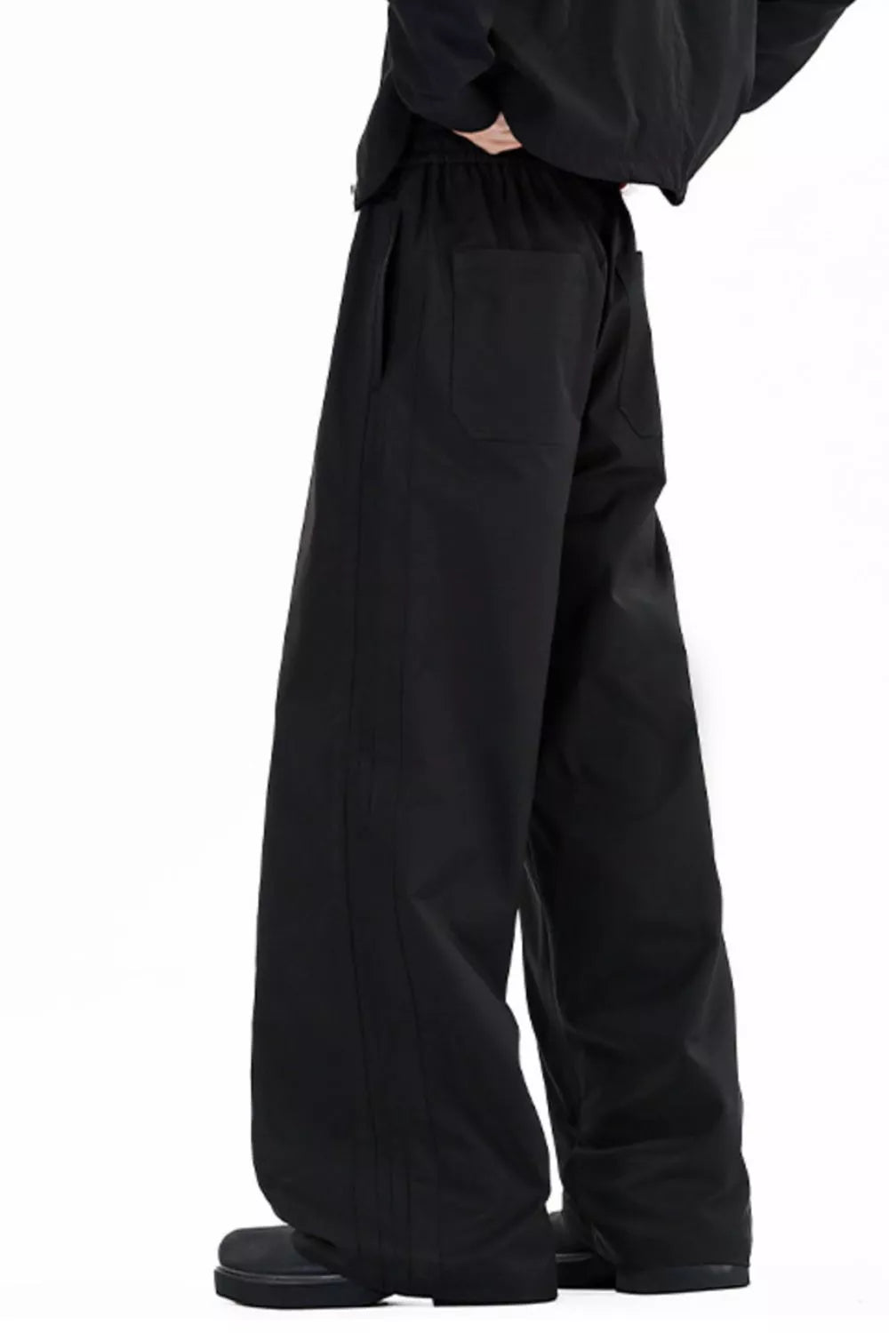 Men's wide leg casual pants with a drawstring waist and pockets.