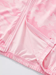 Close view of the open zip, pale pink lining and elastic hem on the camouflage jacket
