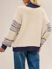 Back view of the cream waffle knit sweater with navy mock neck and patterned sleeves.