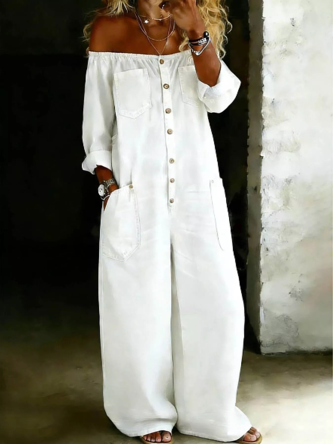 Women's off-shoulder jumpsuit with front buttons, wide legs, and pockets.