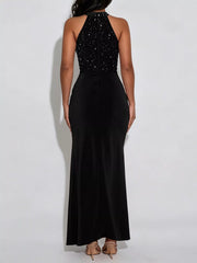 Back view of black sleeveless maxi dress with rhinestone halter bodice on model