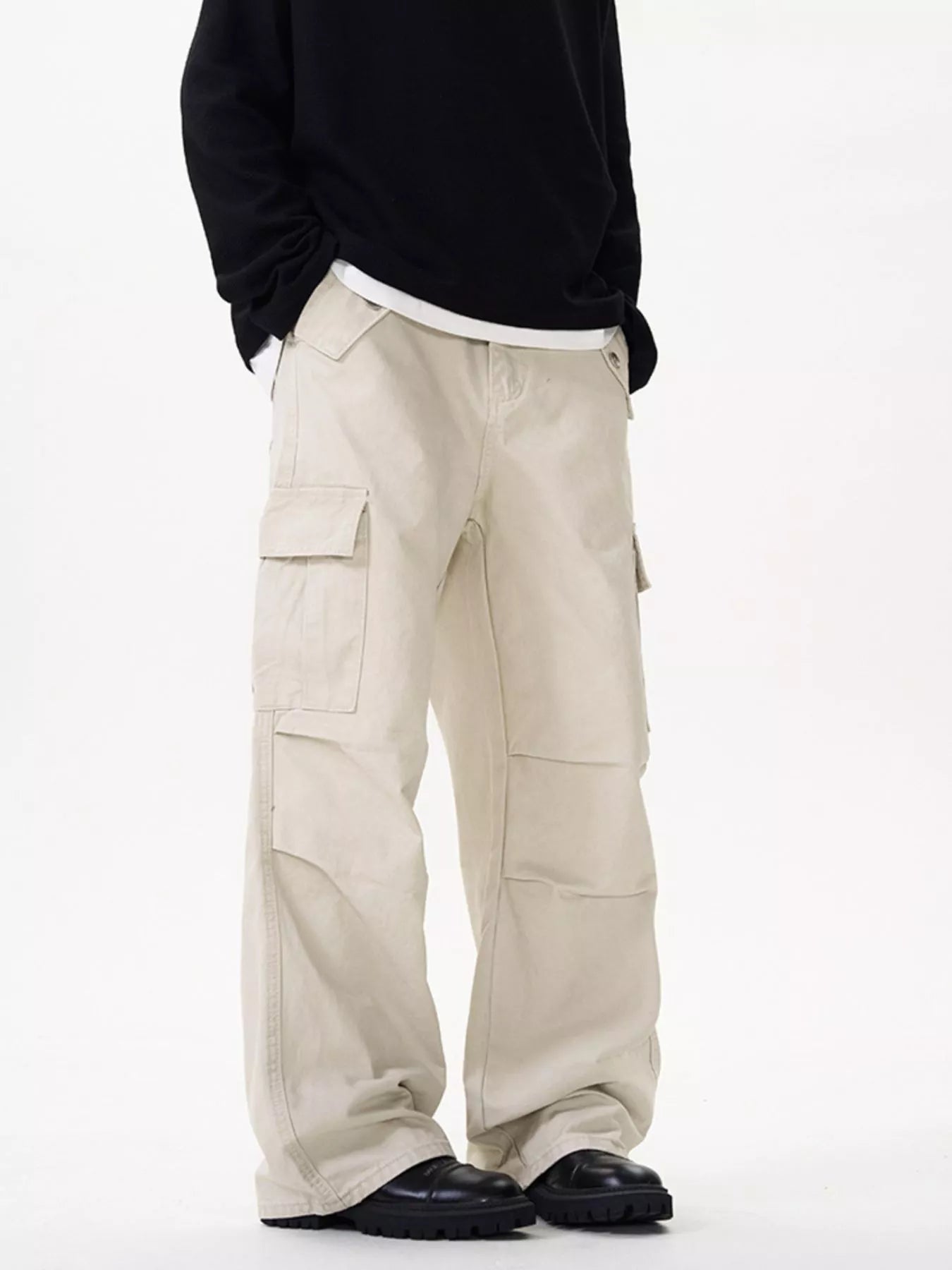 Men's creamy-white cotton cargo pants with a loose fit and pockets.