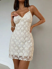 White floral lace bodycon mini dress, front view with hand near neckline