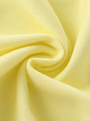 Close-up texture of the soft light yellow fabric of the children's short sleeve shirt