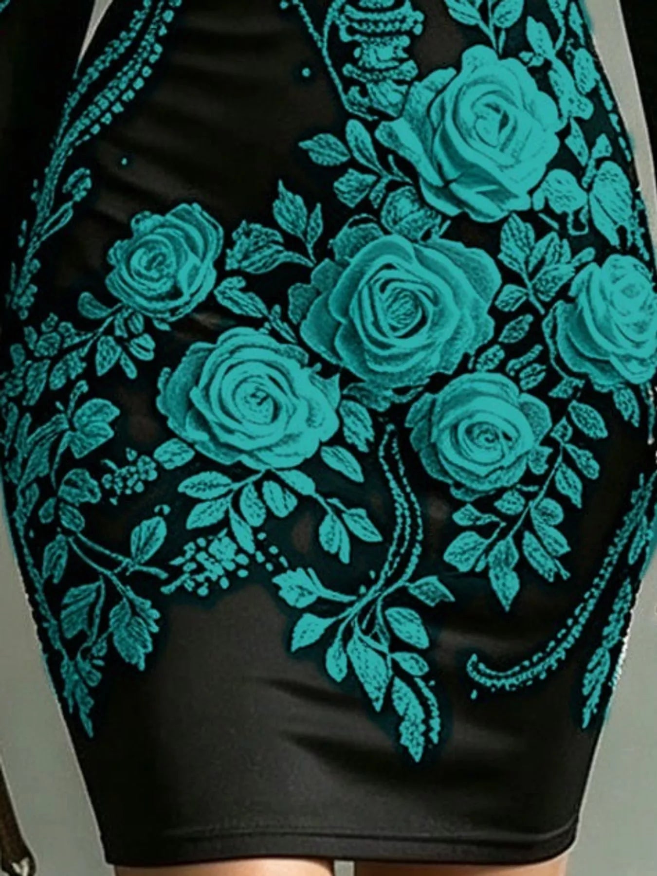 Close detail of teal rose print on black long sleeve bodycon dress skirt