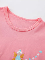 Close view of the round neckline and the top of a fairy graphic on the blush pink T-shirt