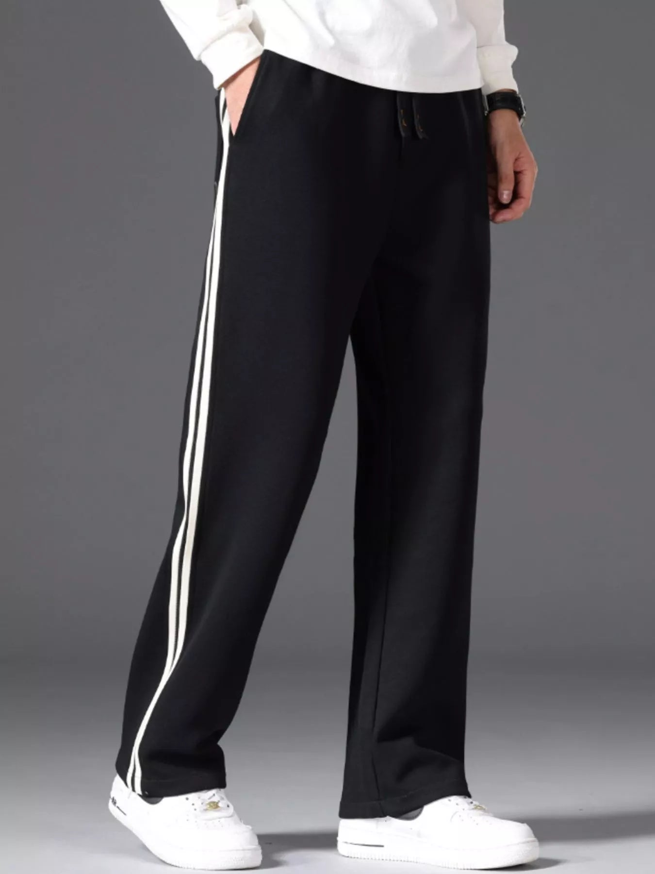 Men's side striped casual pants with a drawstring waist and pockets.