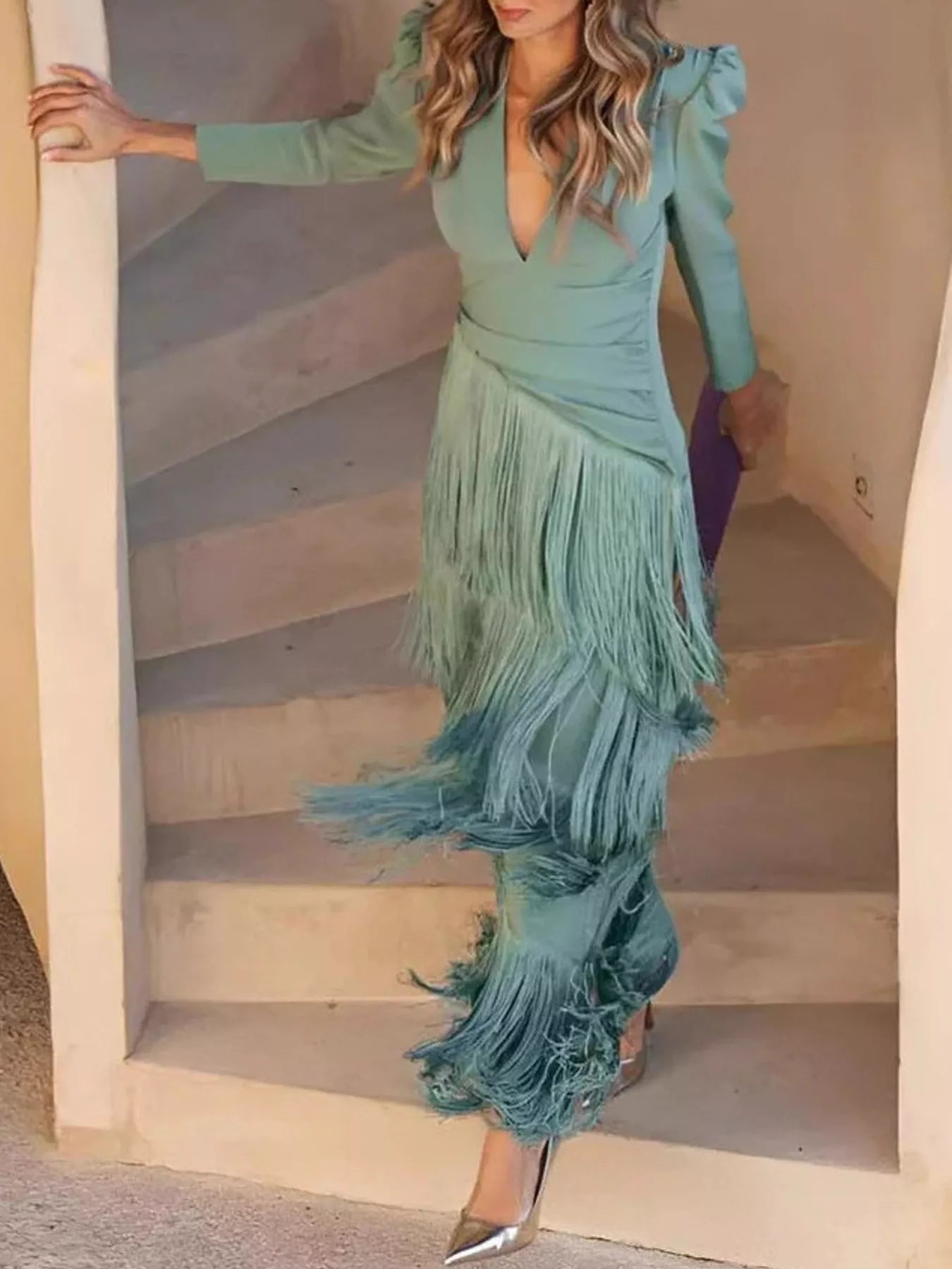 Full length view of a gum leaf green fringed maxi dress worn walking down outdoor stairs