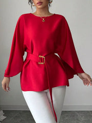 Red batwing sleeve blouse front view with arms extended showing flowing sleeves and belted waist